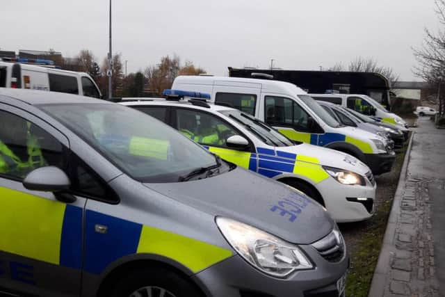 Lines of police vehicles await deployment