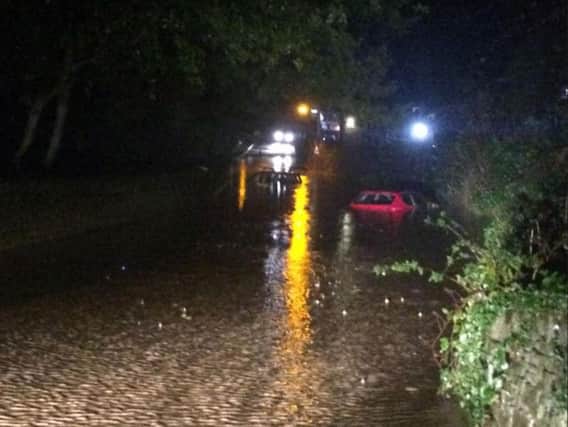 Cars were stranded in floodwater in Hathersage