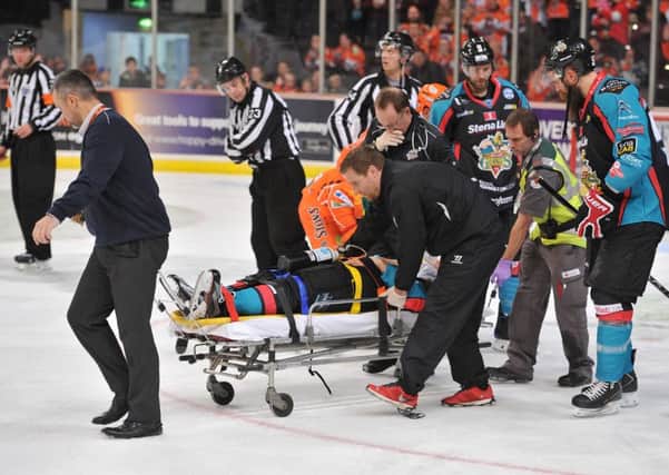 Injured David Rutherford is stretchered off. Pic Dean Woolley