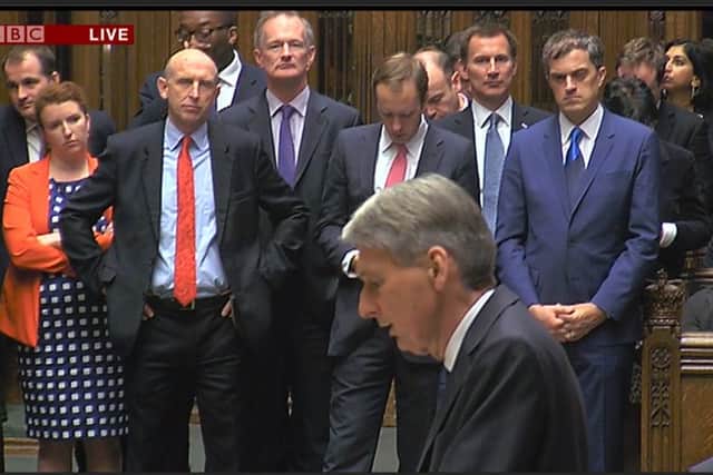 John Healey, in the red tie, listens to Chancellor Philip Hammond