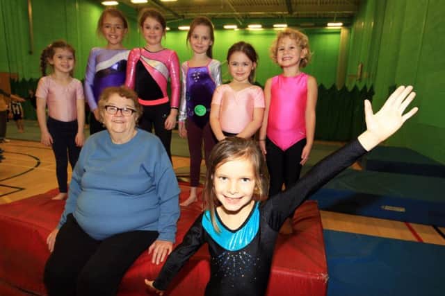 Hillsborough gymnastics coach June Adams with some of her students at Ecco Gymnastics Club.
