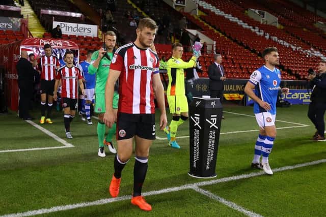 Jack O'Connell leads out the Sheffield United team to face Walsall in the Checkatrade Trophy at Bramall Lane in October
