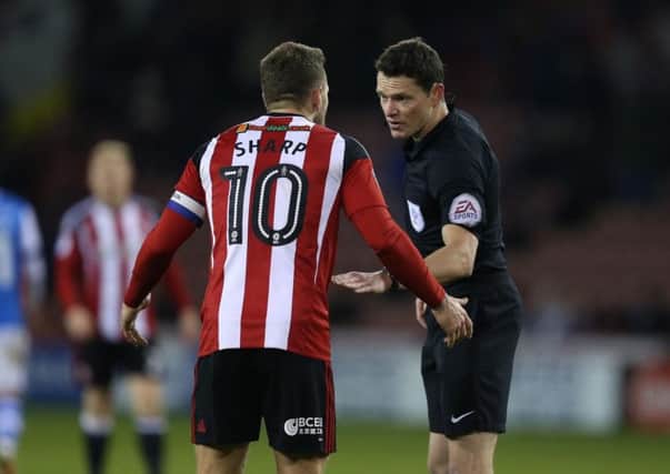 Referee Darren England has a word with Sheffield United's Billy Sharp