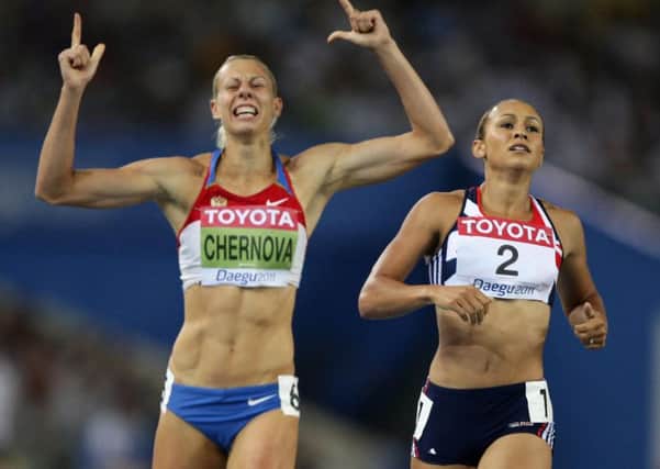 Russia's Tatyana Chernova (left) celebrates as she finishes the behind Great Britain's Jessica Ennis.