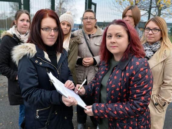 Cally Bell, front left, with her petition and other concerned parents outside North Wingfield Primary School. Picture: Brian Eyre.