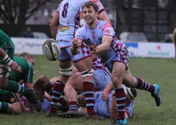 George Tressider sprays the ball out for Titans. Photo: Simon Hall