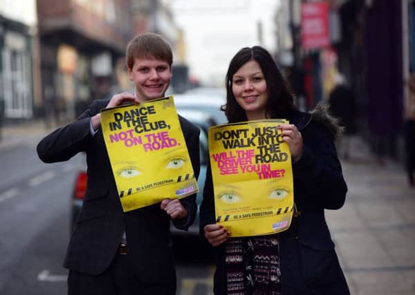 Councillor George Lindars-Hammond and road safety officer Tracy Hendry, on Devonshire Street in Sheffield, with posters promoting  'Be A Safe Pedestrian' road safety campaign to help festive revellers to stay safe this winter. Picture Scott Merrylees
