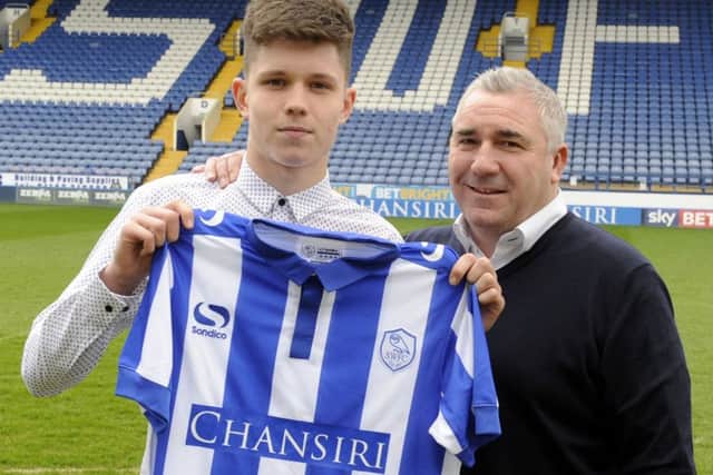 George Hirst after signing pro forms for  Wednesday, with his dad club legend  David.