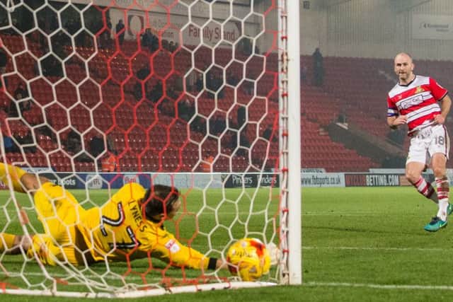 Doncaster Rovers' Paul Keegan slots his penalty in the corner past Blackpool's Dean Lyness in the shootout