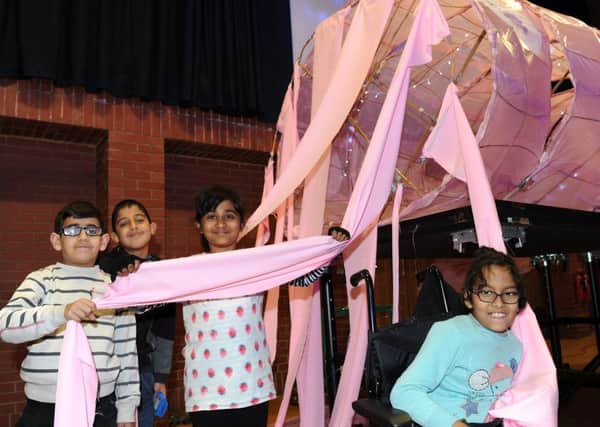 Pupils of Sharrow Primary hold the tentacles of a giant squid which has been made for an interactive lecture about sea life at the Octagon.
