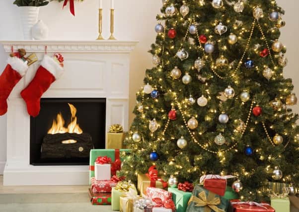 Christmas tree with presents and fireplace with stockings --- Image by Â© Royalty-Free/Corbis