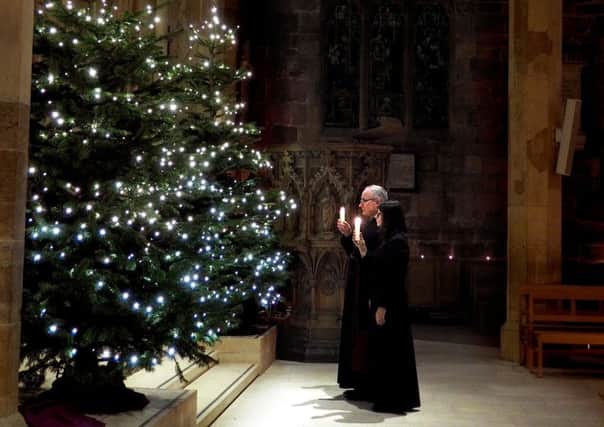 Advent at Sheffield Cathedral: Canon Keith Farrow and Rev Beth Keith  looking into the chancel with their advent candles