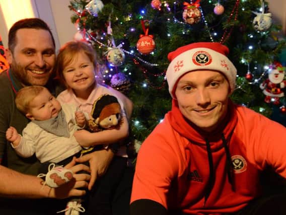 Sheffield United star Caolan Lavery with John Newton, 15-month-old Charlotte and 4-year-old Emily Newton at Bluebell Wood Children's Hospice