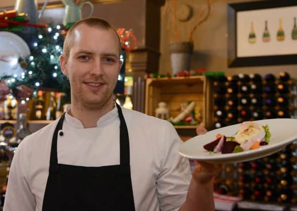 The Cricket Inn Totley food review Head chef Sam Parnell holding a goats cheese with chargrilled little gem and textures of beetroot
