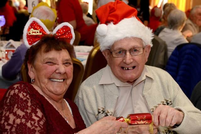 Christmas lunch at the Niagara conference centre for people who live alone and feel isolated over Christmas. Ronald Lodd and Joan Dawson pull a cracker