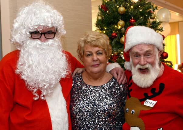 Christmas lunch at the Niagara conference centre for people who live alone and feel isolated over Christmas. Santa with Gloria Stewart with Peter