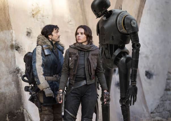 Undated Film Still Handout from Rogue One: A Star Wars Story. Pictured: Cassian Andor (Diego Luna), Jyn Erso (Felicity Jones) and K-2SO (Alan Tudyk). See PA Feature FILM Reviews. Picture credit should read: PA Photo/Lucasfilm. WARNING: This picture must only be used to accompany PA Feature FILM Reviews.