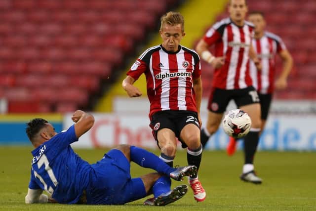 Louis Reed of Sheffield Utd tackled by Marcin Wasilewski of Leicester City U23.