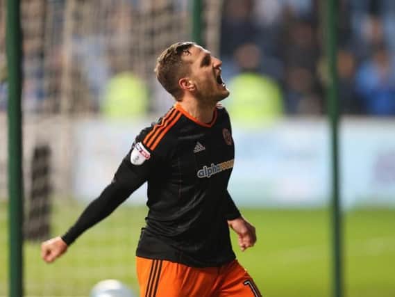 Billy Sharp celebrates one of two goals against Coventry City