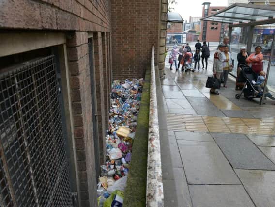 Piles of litter thrown down by a wall near to the old Town Hall just yards from a bin in Sheffield city centre