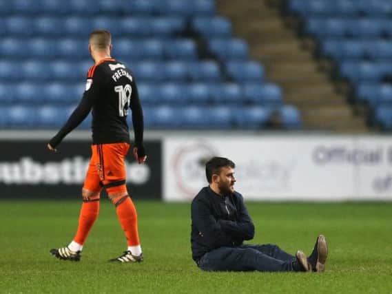 A protester disrupts the early stages of Sheffield United's match at Coventry City