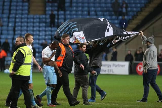 Coventry City fans invade the pitch in protest at the club's owners