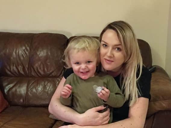 Noah Oxley, who survived falling from a bedroom window, with mum Emma
