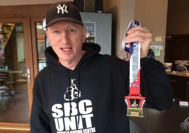 John McCormack with his finisher medal after completing the Philadelphia Marathon