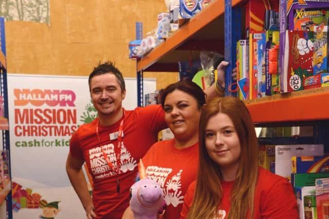 Staff at the Mission Christmas HQ, with some of the gifts donated for the appeal