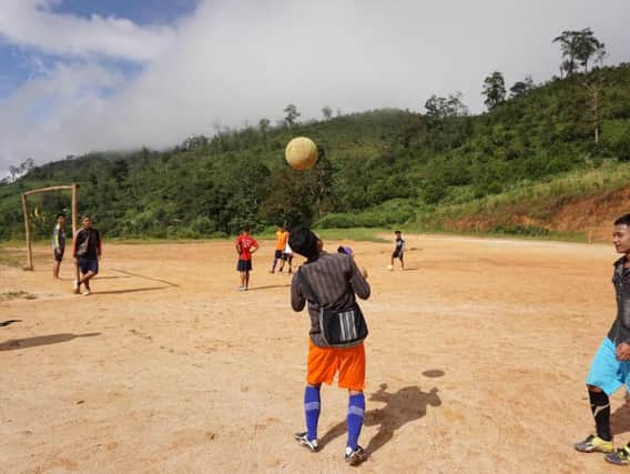 Burmese refugees play football in Umpiem Mai camp in Thailand.