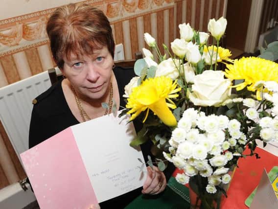Linda Heald with the card and flowers brought by her Tesco delivery driver after the death of her husband David.