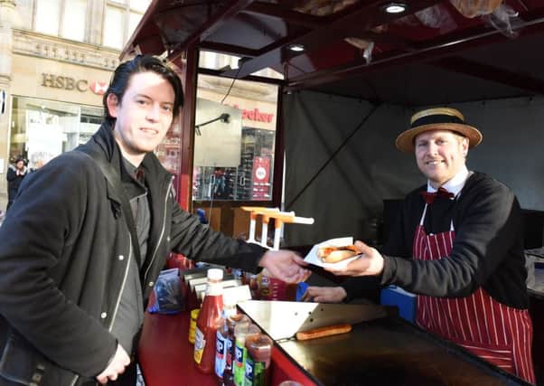Michael McCurtin will wind up his Hot Sausage Company later this month. He's pictured with customer Dan Jenkinson