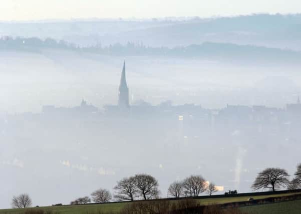 Chesterfield's famous crooked spire pokes through the fog.  Picture  Chris Lawton