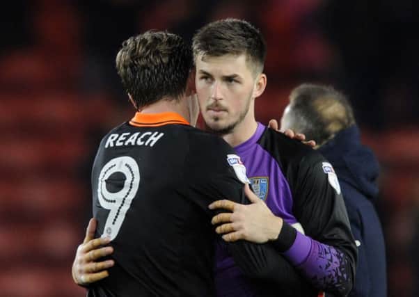 Owls Joe Wildsmith gets a hug from Adam Reach at the final whistle