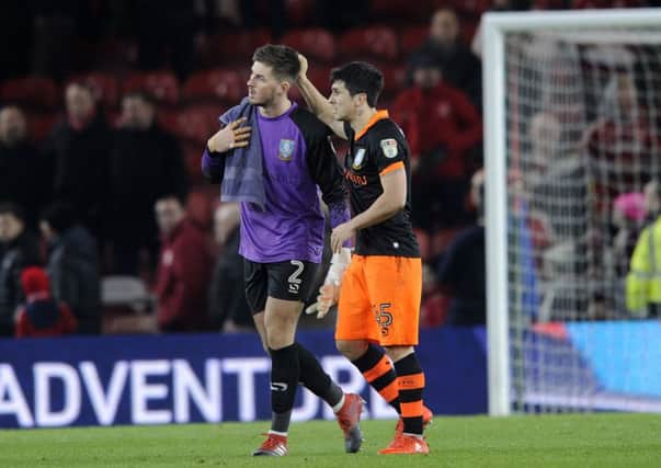 Owls Joe Wildsmith gets a pat at the final whistle from Fernando Forestieri