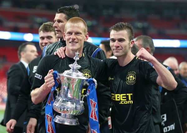 Wigan Athletic winning goalscorer Ben Watson celebrates with team-mate Callum McManaman (right) and the FA Cup trophy after the FA Cup Final at Wembley Stadium back in 2013