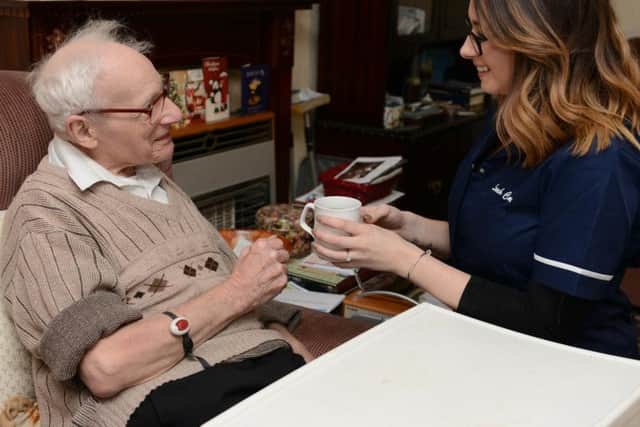 Albert, aged 92, of Manor Top, was conned out of 10,000 by doorstep salesman. Albert is pictured with care worker Danielle Paling