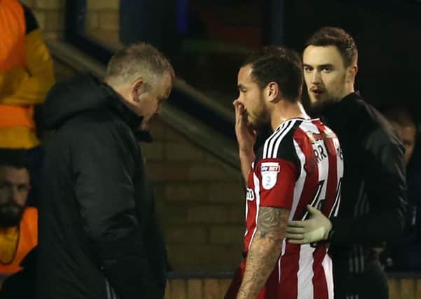 Sheffield United's Samir Carruthers goes off injured as Chris Wilder looks on