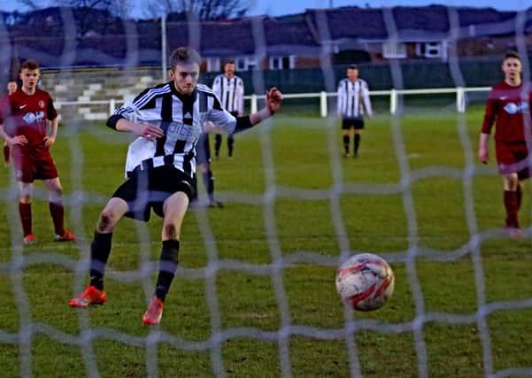 Debutant Ryan Smith puts Penistone Church 3-0 up from the penalty spot in the 4-0 win against Nostell MW. Photo: Ian Revitt