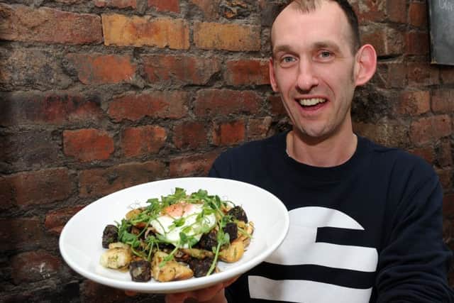 Jonty Cork holds up a wild mushroom, black pudding and new potato hash with a fried egg dish at Made By Jonty, Sharrow Vale Road.