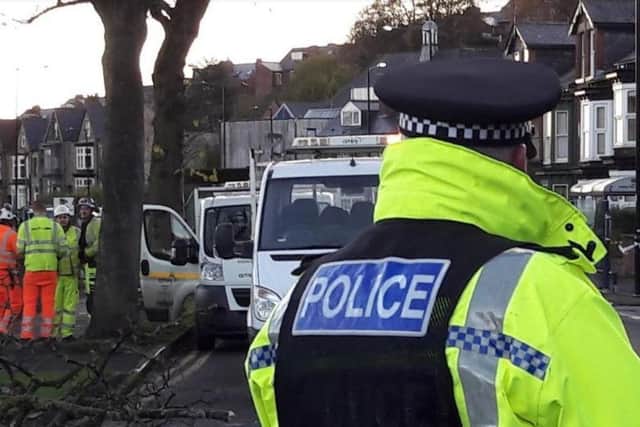 Police in Rustlings Road, where council contractors began felling trees at 5am