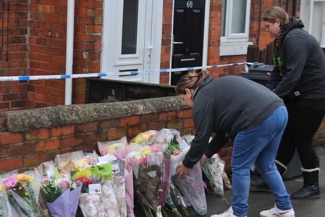 Mourners lay floral tributes close to where Leonne Weeks' body was found in Dinnington