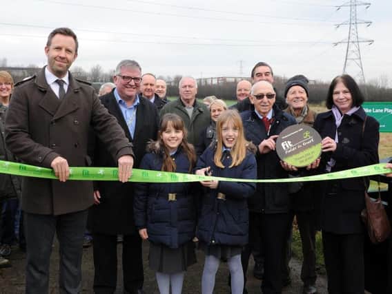 Youngsters cut a ribbon at Ochre Dike Playing Fields to celebrate its new protected status