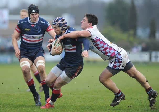 Knights' Dougie Flockhart is tackled in the Titans derby . Picture Scott Merrylees