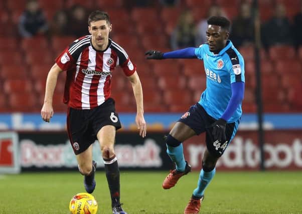 Chris Basham of Sheffield Utd in action with Devante Cole of Fleetwood Town. Pic: Simon Bellis/Sportimage