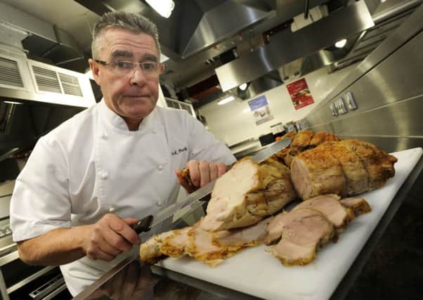 Sheffield City College,Dept of Hospitality,Catering.Bakery,and Aviation...BUDGET XMAS LUNCH FEATURE...Mick Burke,Senior Chef Lecturer,carving Turkey