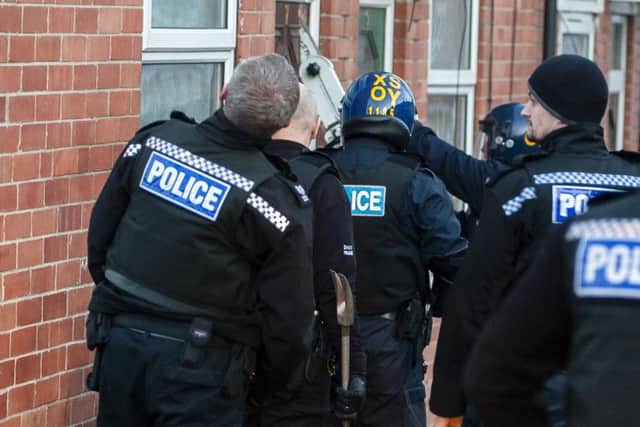 Police prepare to execute a warrant at an address in Rotherham. Like the majority of raids South Yorkshire Police carry out, this was at the correct address. Picture: Paul Drabble