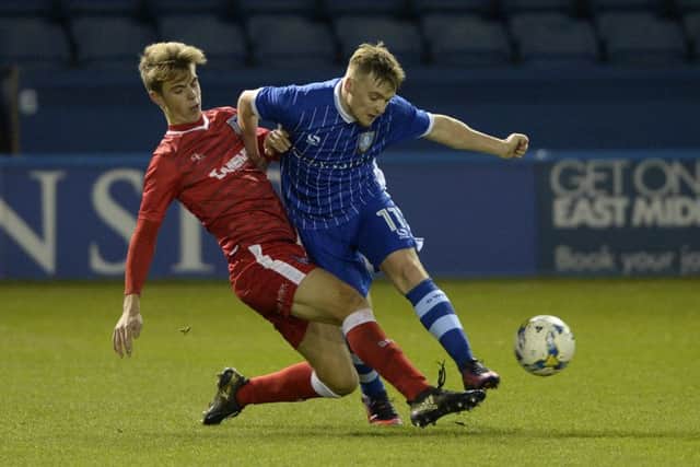 Fraser Preston survives a challenge from Jack Tucker. Sheffield Wednesday U18 v Gillingham U18.  FA Youth Trophy Fourth Round.  6 January 2017.  Picture Bruce Rollinson