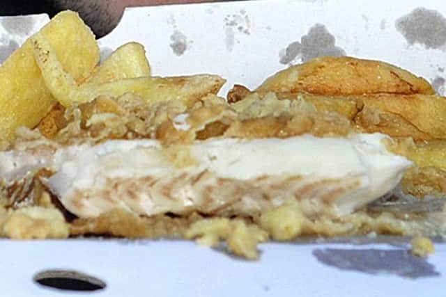 Eating a portion of fish and chips from a takeaway