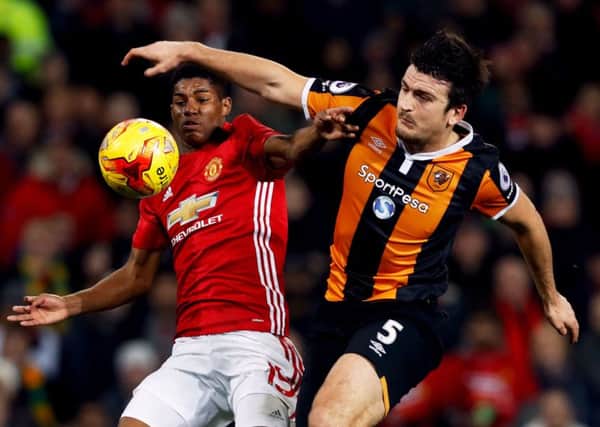 Manchester United's Marcus Rashford (left) and Hull City's Harry Maguire battle for the ball
